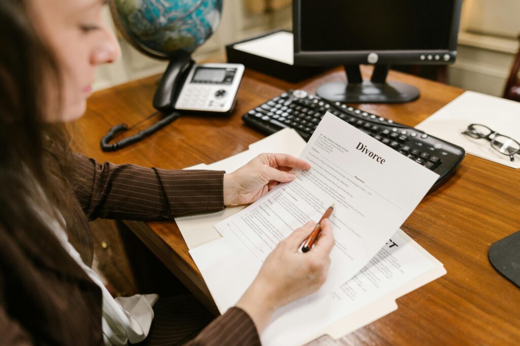 pexels photo 7841450 7841450 A lawyer examines divorce documents at a desk in a law office setting, emphasizing professionalism.